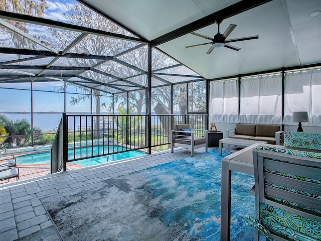 view of swimming pool with outdoor lounge area, a patio area, ceiling fan, and a lanai