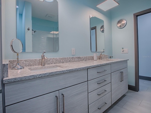 bathroom with tile patterned floors, vanity, and walk in shower