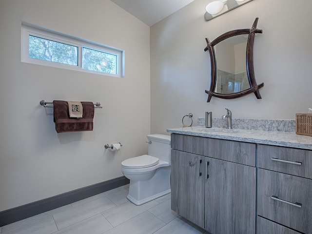 bathroom with vanity, toilet, and tile patterned floors