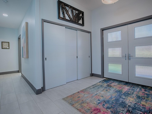 tiled entryway featuring french doors