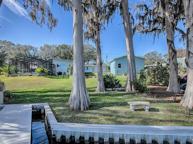 view of yard featuring a lanai and a dock