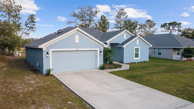 single story home with a garage and a front lawn