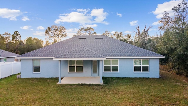 back of property featuring a patio area and a lawn