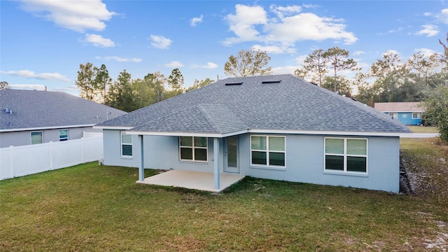 back of property featuring a yard and a patio area