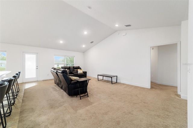 carpeted living room featuring lofted ceiling