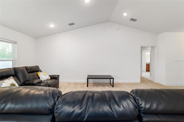 carpeted living room with lofted ceiling