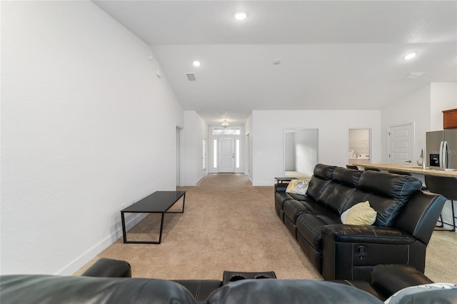 living room with vaulted ceiling and light carpet