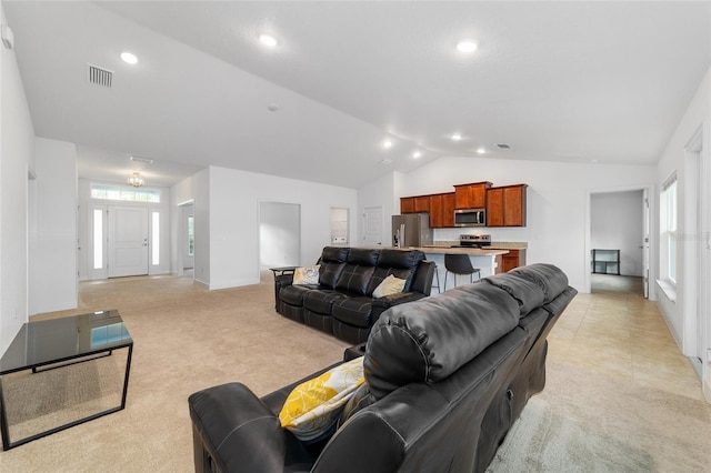 living room featuring light carpet and lofted ceiling