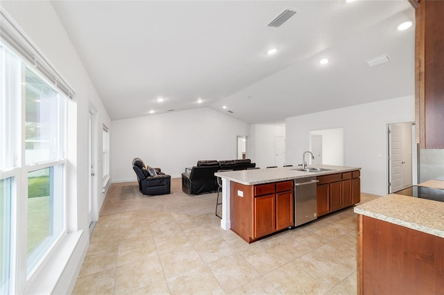 kitchen with lofted ceiling, sink, a center island with sink, light tile patterned flooring, and stainless steel dishwasher