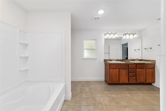 bathroom with tile patterned floors, vanity, and a bathing tub