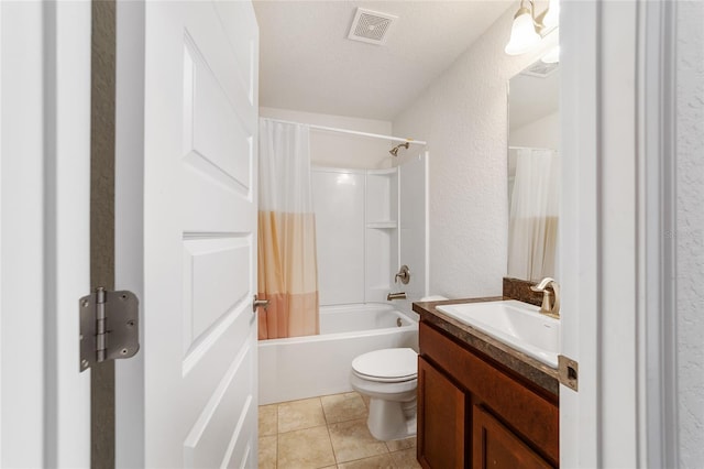 full bathroom featuring vanity, shower / bath combination with curtain, a textured ceiling, tile patterned floors, and toilet