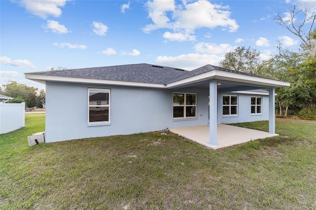 rear view of property with a patio and a yard