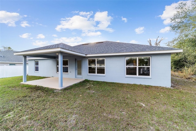 rear view of property featuring a patio and a yard