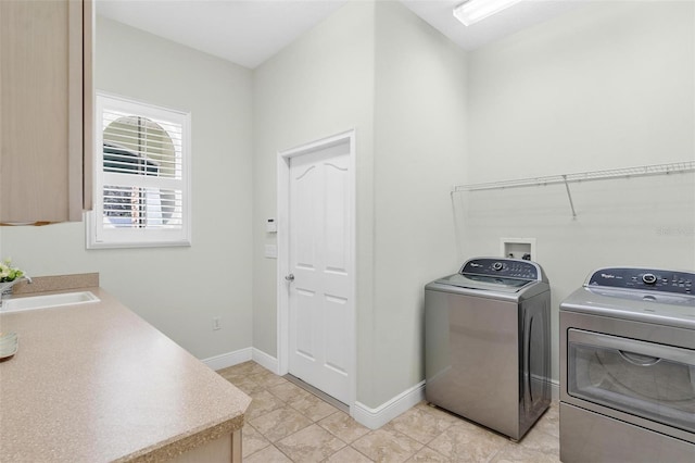 washroom with separate washer and dryer and sink