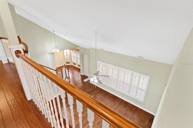 stairs featuring high vaulted ceiling and hardwood / wood-style floors