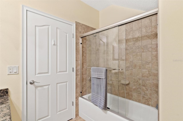 bathroom with shower / bath combination with glass door