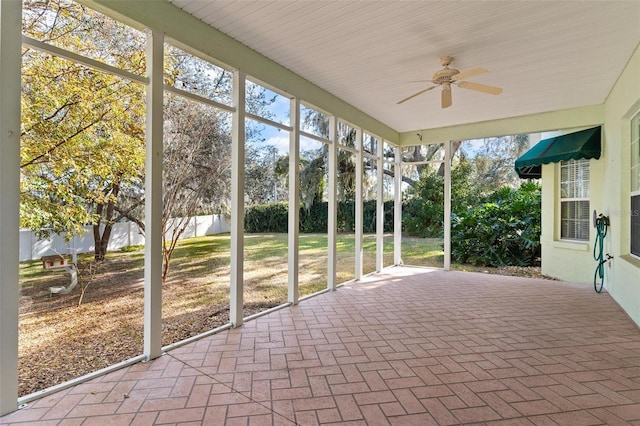 unfurnished sunroom featuring ceiling fan