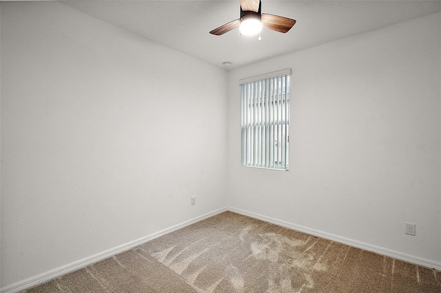 carpeted spare room featuring ceiling fan