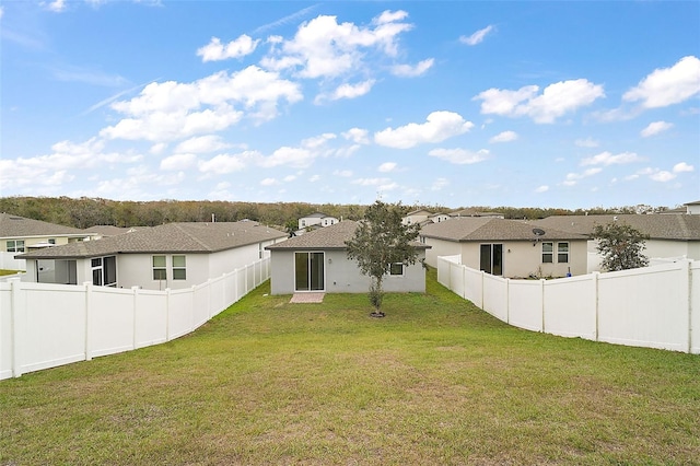 back of property featuring a yard