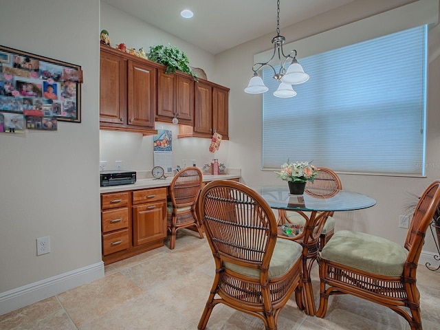 tiled dining space with an inviting chandelier