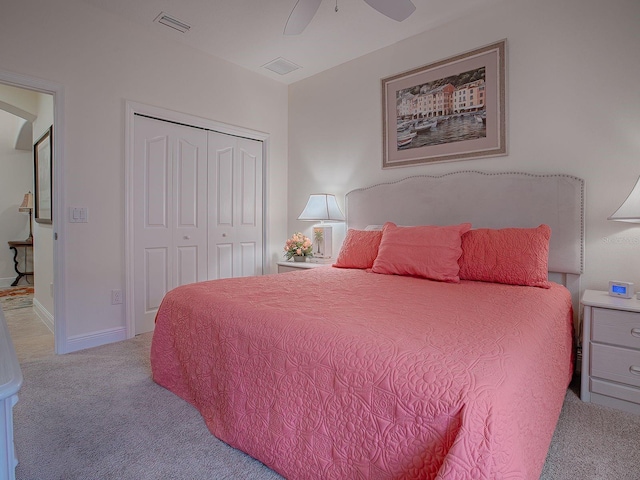 bedroom with ceiling fan, a closet, and light carpet