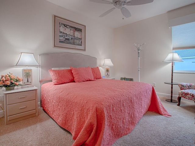 bedroom featuring ceiling fan and light carpet