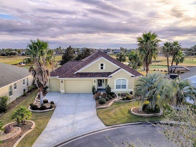 single story home featuring a lawn and a garage