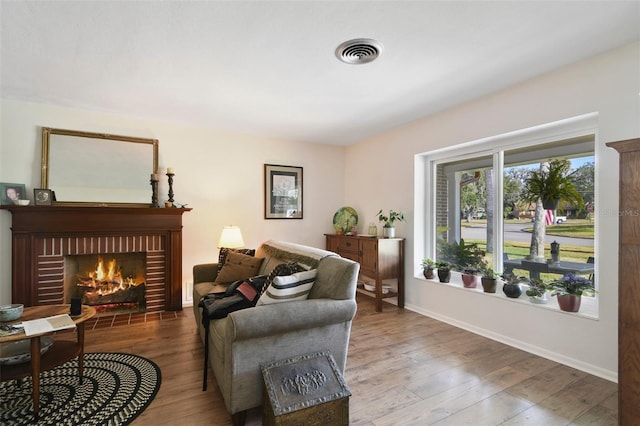 living area featuring hardwood / wood-style floors and a fireplace