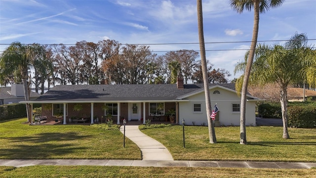 single story home with a front lawn and covered porch