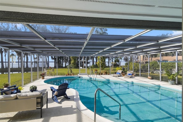 view of swimming pool featuring a yard, a patio area, and glass enclosure