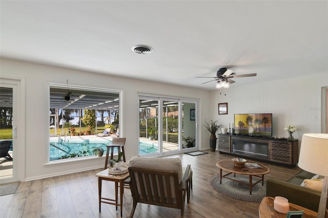 living room featuring hardwood / wood-style floors and ceiling fan