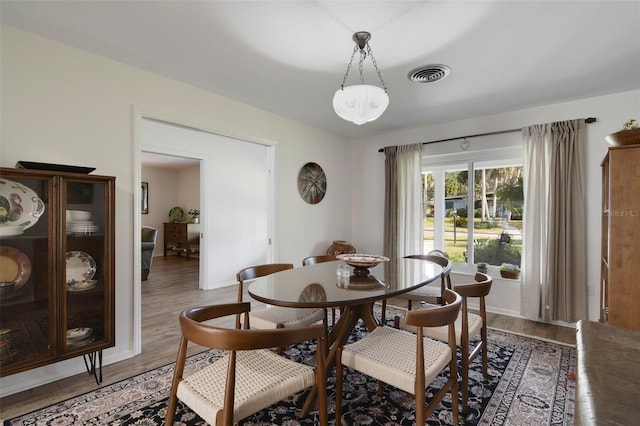 dining area with hardwood / wood-style flooring