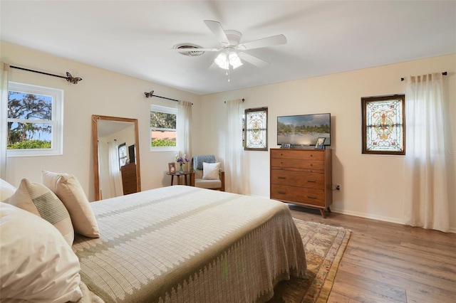 bedroom with wood-type flooring and ceiling fan