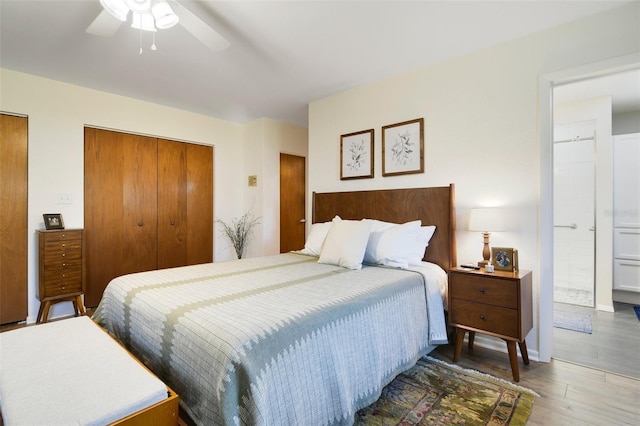 bedroom with connected bathroom, hardwood / wood-style flooring, and ceiling fan