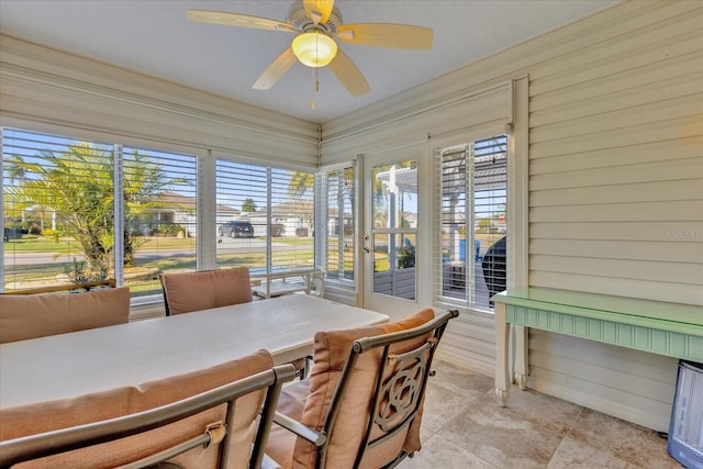 sunroom / solarium featuring ceiling fan