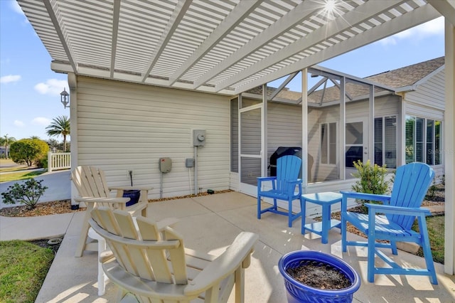 view of patio featuring a pergola and glass enclosure