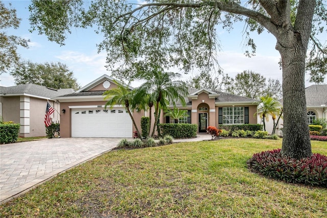 ranch-style home featuring a garage and a front lawn