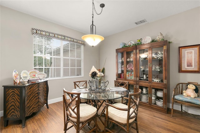 dining space with wood-type flooring