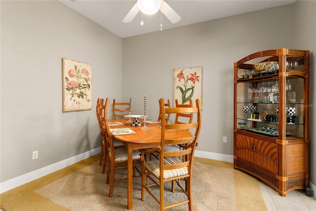 tiled dining space featuring ceiling fan