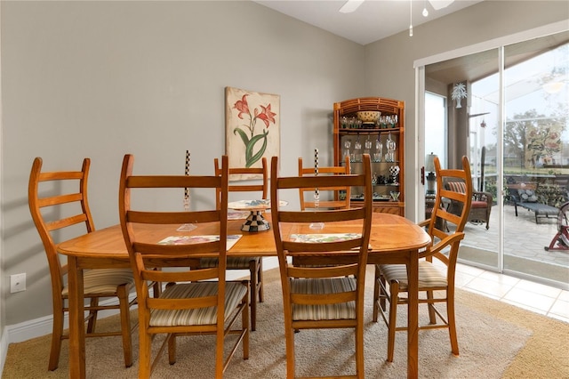 dining area with ceiling fan and tile patterned floors