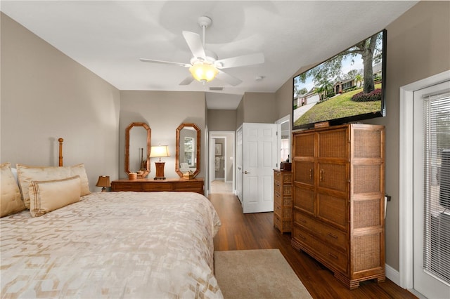 bedroom with ceiling fan and dark wood-type flooring