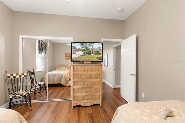 bedroom featuring a closet and dark hardwood / wood-style floors