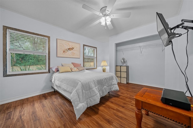 bedroom with ceiling fan, baseboards, and wood finished floors