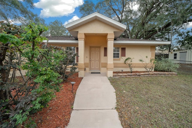 view of front of property featuring fence and stucco siding