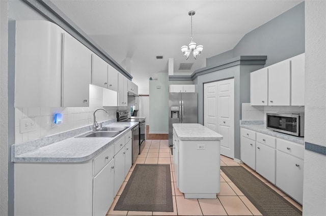 kitchen featuring light tile patterned floors, a sink, light countertops, appliances with stainless steel finishes, and tasteful backsplash