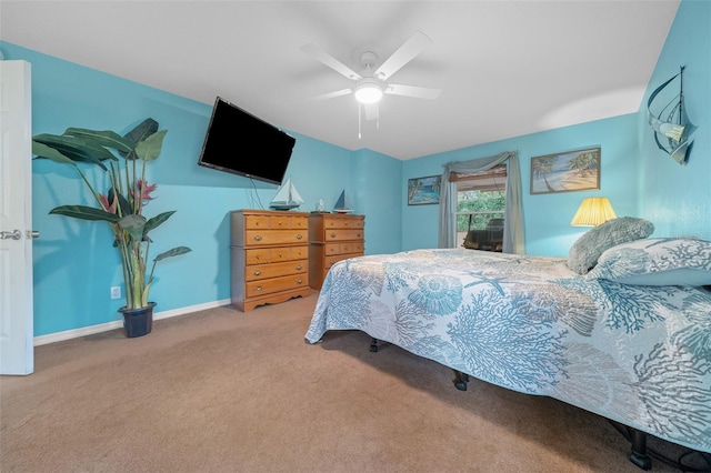 carpeted bedroom with baseboards and a ceiling fan