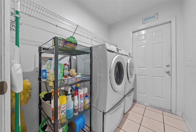 laundry area featuring light tile patterned floors, laundry area, and washer and dryer