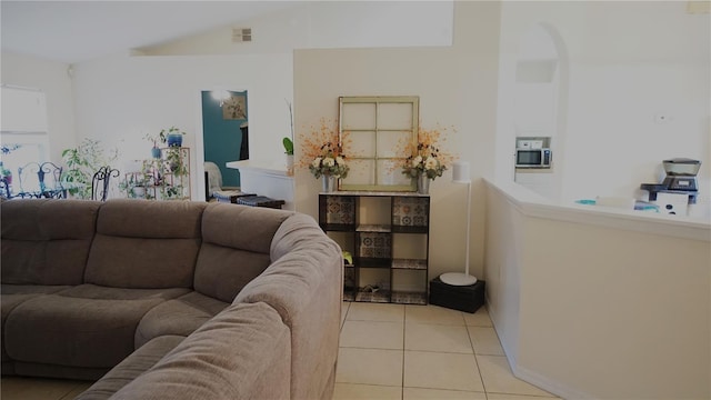 tiled living room with vaulted ceiling