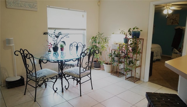 tiled dining area featuring ceiling fan