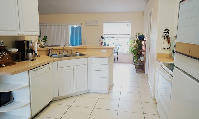 kitchen featuring white cabinetry, sink, light tile patterned floors, kitchen peninsula, and white appliances